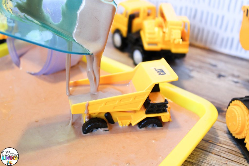 oobleck scooped into a bin with trucks and other toys- oobleck recipe printable